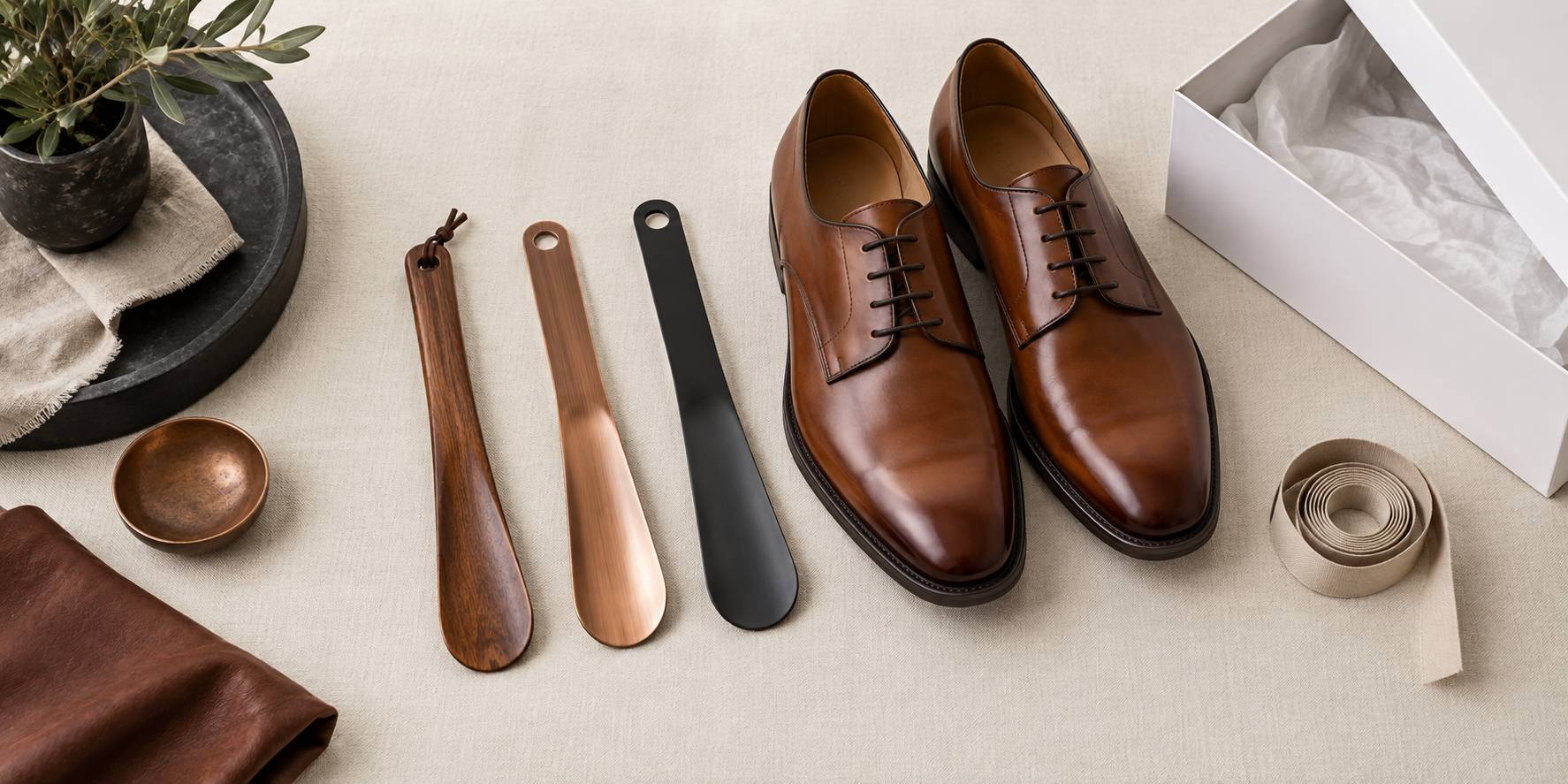 Trois chausse-pieds de matieres differentes et une paire de derbies sur un lin clair